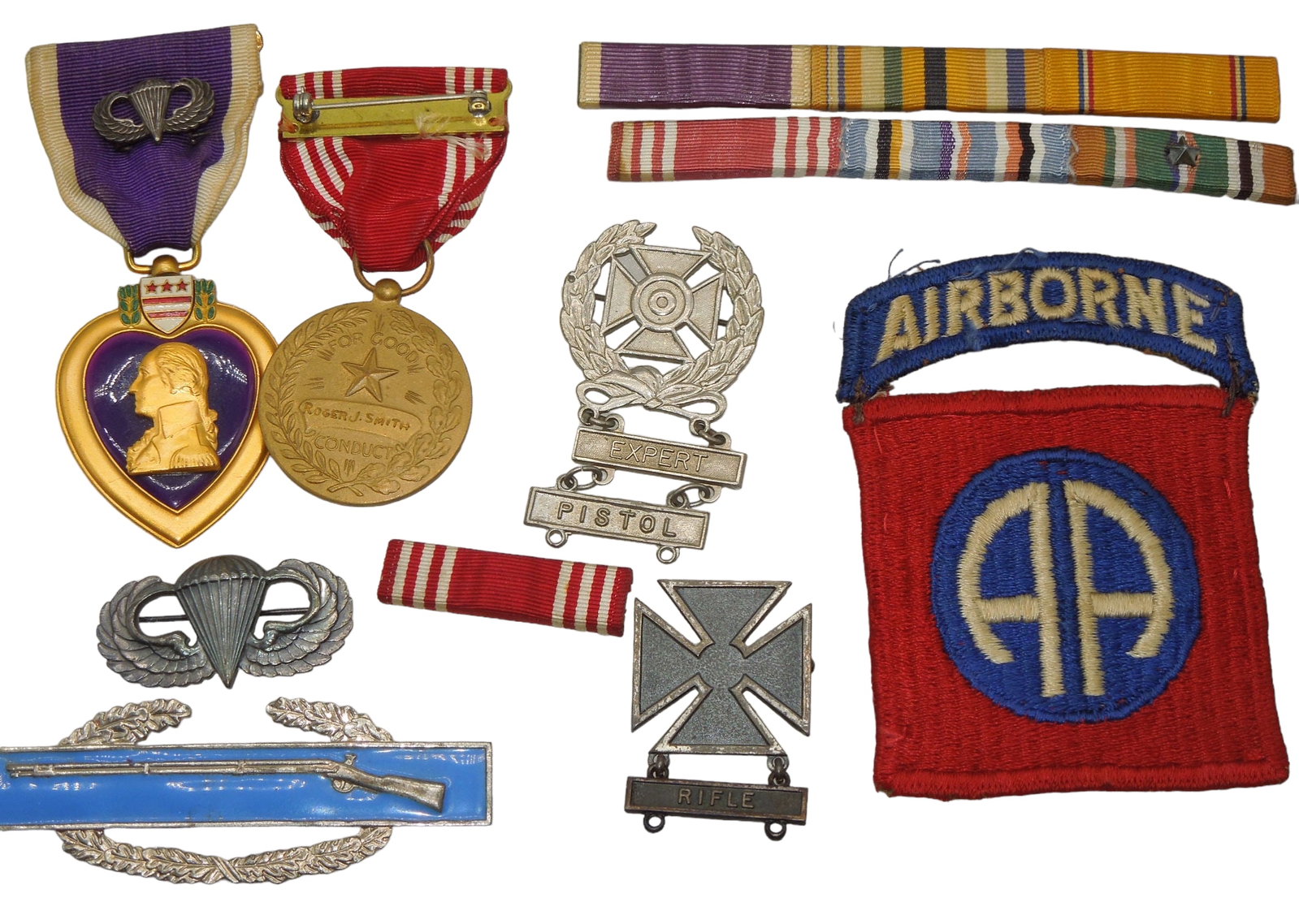 WWII Named 502nd Parachute Infantry Regiment Purple Heart Medal Group: WWII named 502nd PIR / 82nd Airborne group from a North Carolina Vet, Corporal Roger J. Smith, wounded early after jumping into Normandy on D-Day. Group was acquired as is all together, and we are not