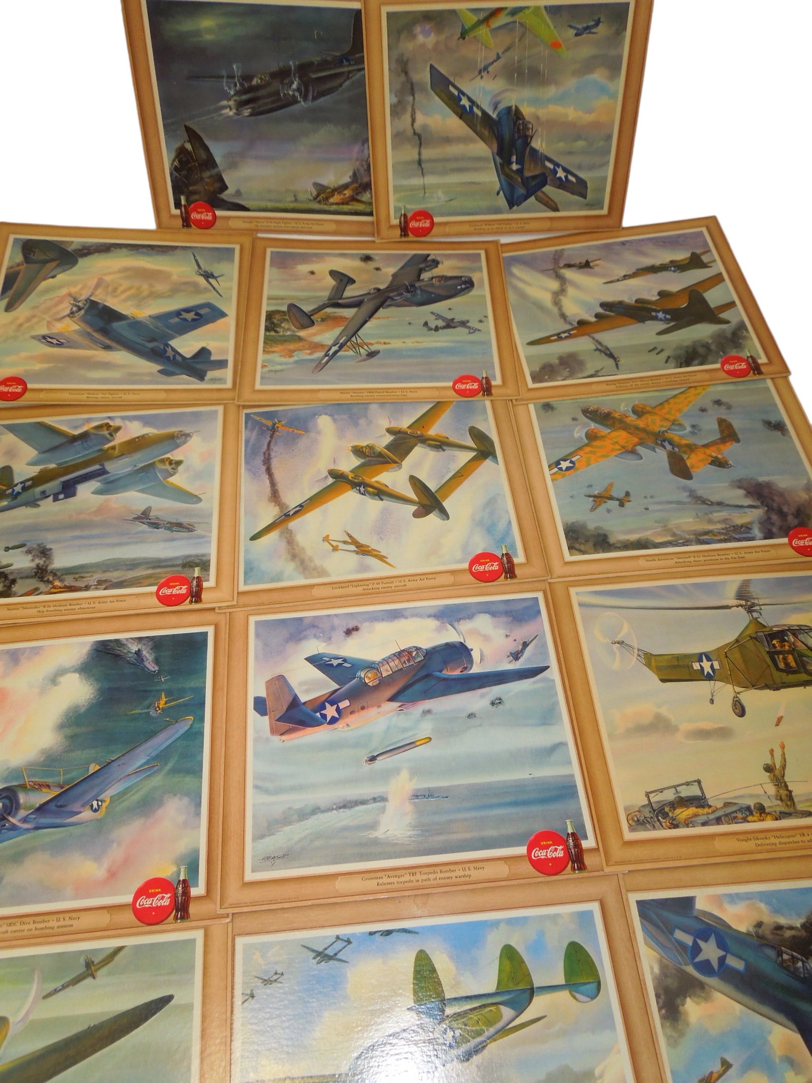 WWII 1943 Coca Cola US Navy & Army Air Force Aircraft Advertisement Poster Boards Lot: WWII 1943 Navy & Army Air Force Aircraft Coca-Cola Cardboard Lithographs. Created by William Heaslip. You will receive the following (14) lithographs: Navy Corsair F4U Fighter, AAF Constellation C-69 