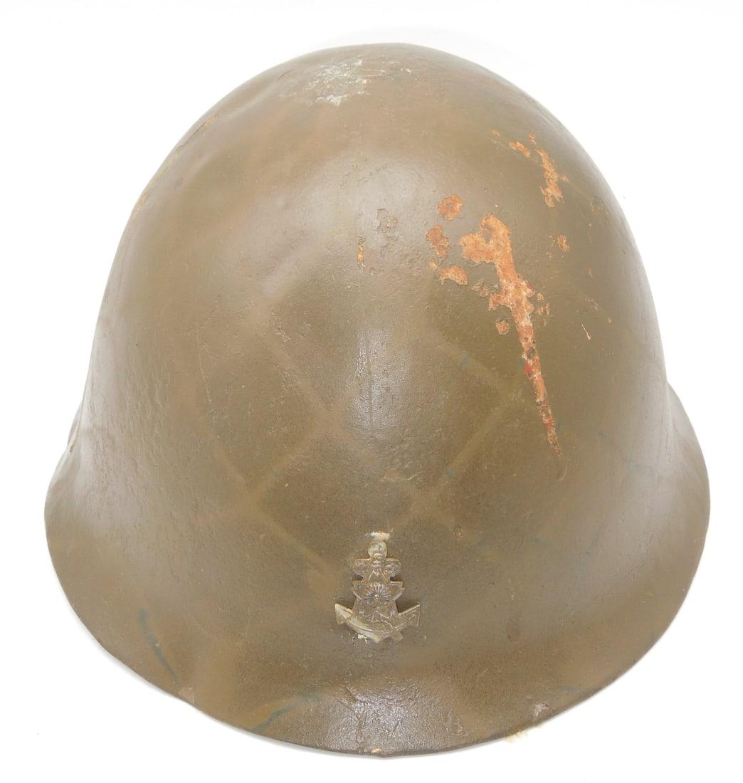 WWII Imperial Japanese Landing Forces Naval Helmet & Badge: Japanese WWII Marine helmet. Helmet had been refurbished some time ago and some of the pitting and dents are still visible. "Mum"/anchor badge on front. A section of burlap was used as a liner. With o
