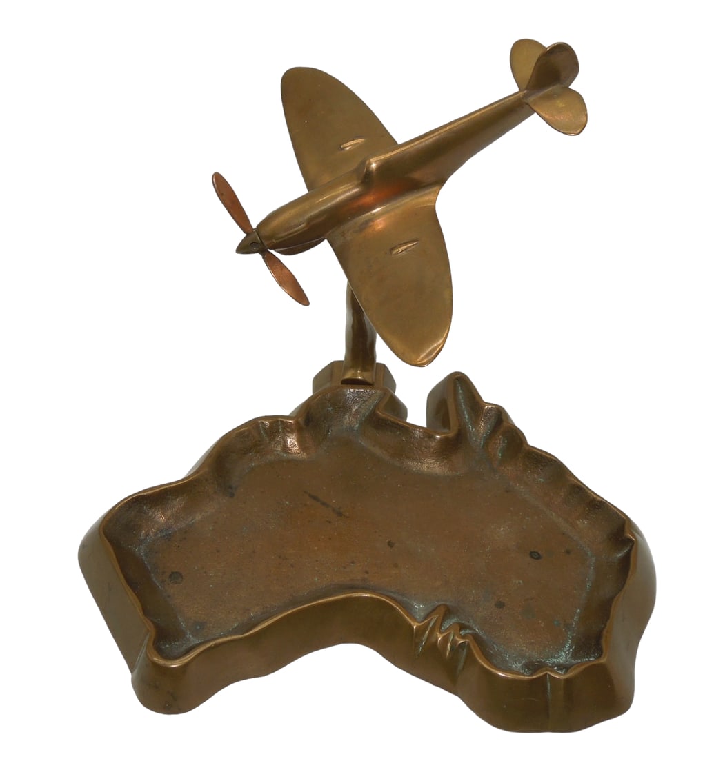 Curtiss SB2C Helldiver Dive Bomber Plane Display Aircraft & Australia Ashtray: Curtiss SB2C Helldiver Dive Bomber Plane Display Aircraft & Australia Ashtray. Brass piece. No markings. Approximate size of aircraft is is 5.5 inches long. The Australia shaped ashtray is 8.25 x 7 in