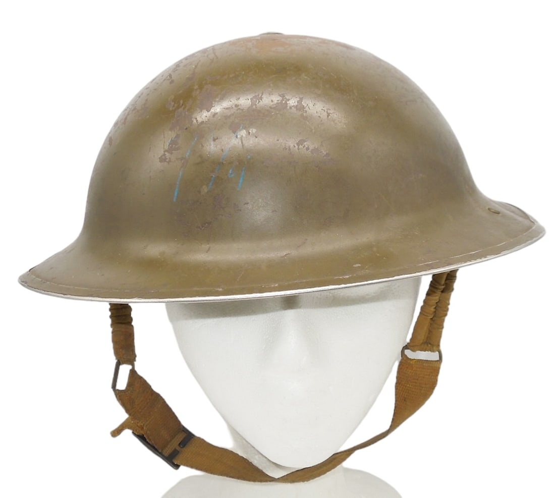 WWII British or Canadian 1942 MKI Helmet: Canadian or British Military Helmet, marked GSW MKI 1942 on the interior. Helmet retains its liner and chinstrap. Exterior paint has some flaking from use.