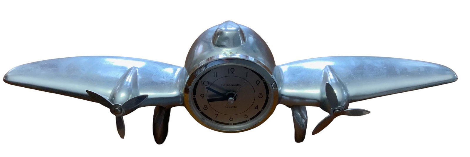 Art Deco Airplane Desk Display Clock Sarsaparilla Quartz: Art Deco Airplane Desk Display Clock with Sarsaparilla Quartz. Cast metal. It appears this clock takes a AA battery. We did test the functionality of this clock to see if it works and it does. Stamped