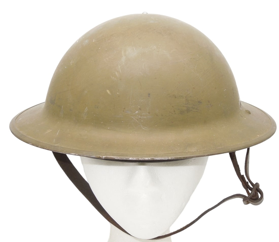 WWII British or Canadian 1942 Dated Brodie Helmet: Original helmet, liner, and chinstrap from WWII. Good condition showing wear consistent with age.