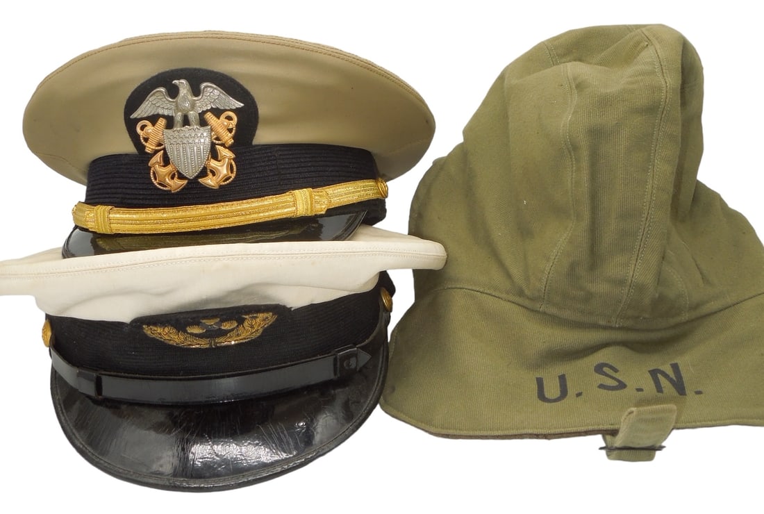 Lot (3) WWII - Vietnam US Navy & Merchant Marine Hats Caps: Lot of three caps: Vietnam War era junior Naval Officer khaki visor cap, a size 7 1/2 Navy Contract Foul Weather USN marked cap, and a WWII - 1950s era merchant sea officer cap with a bullion badge. G