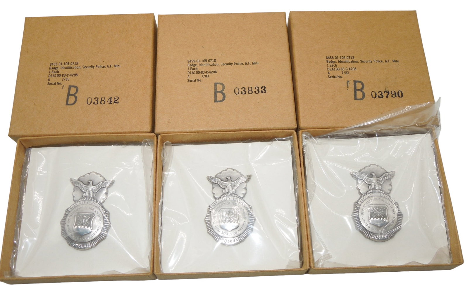 Lot (3) USAF Air Force Security Police 1983 Dated Boxed Mini Badges: Lot of three original unissued mini Security Police USAF badges, numbered, in corresponding matching boxes. Excellent condition.