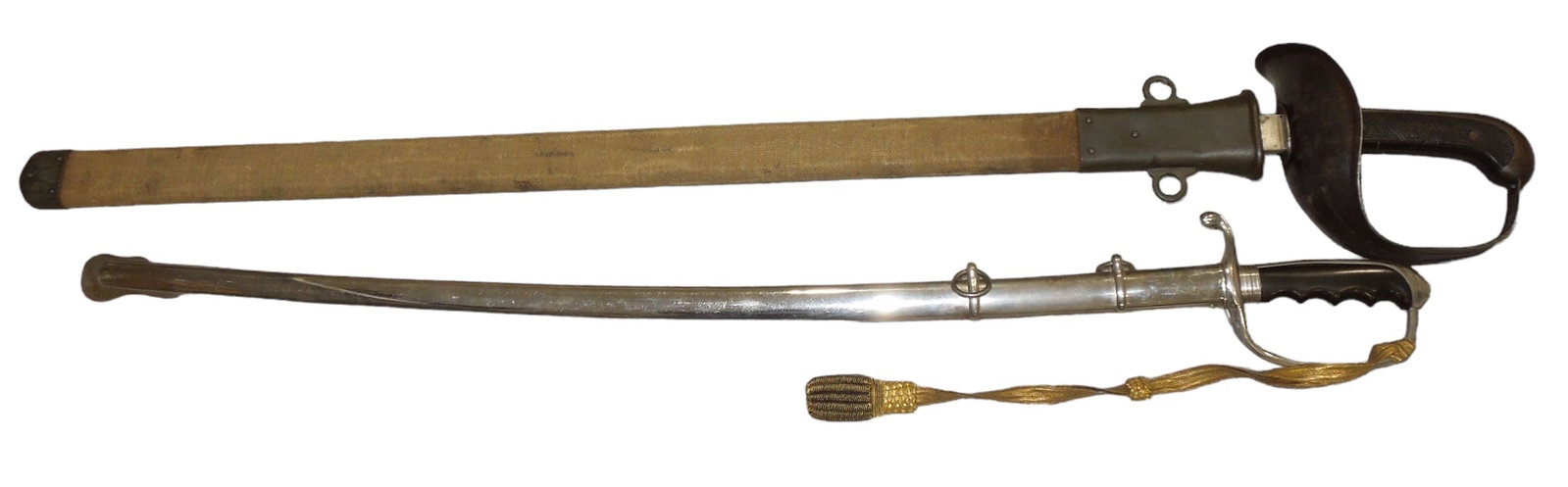 Lot (2) US Military Swords 1913 Patton Saber, M1902 US Officer: Lot of two US swords- A 1913 dated Patton M1913 Cavalry Saber with its original scabbard. Good condition with wear consistent with age. WWII era M1902 Officers sword and scabbard with maker mark and e