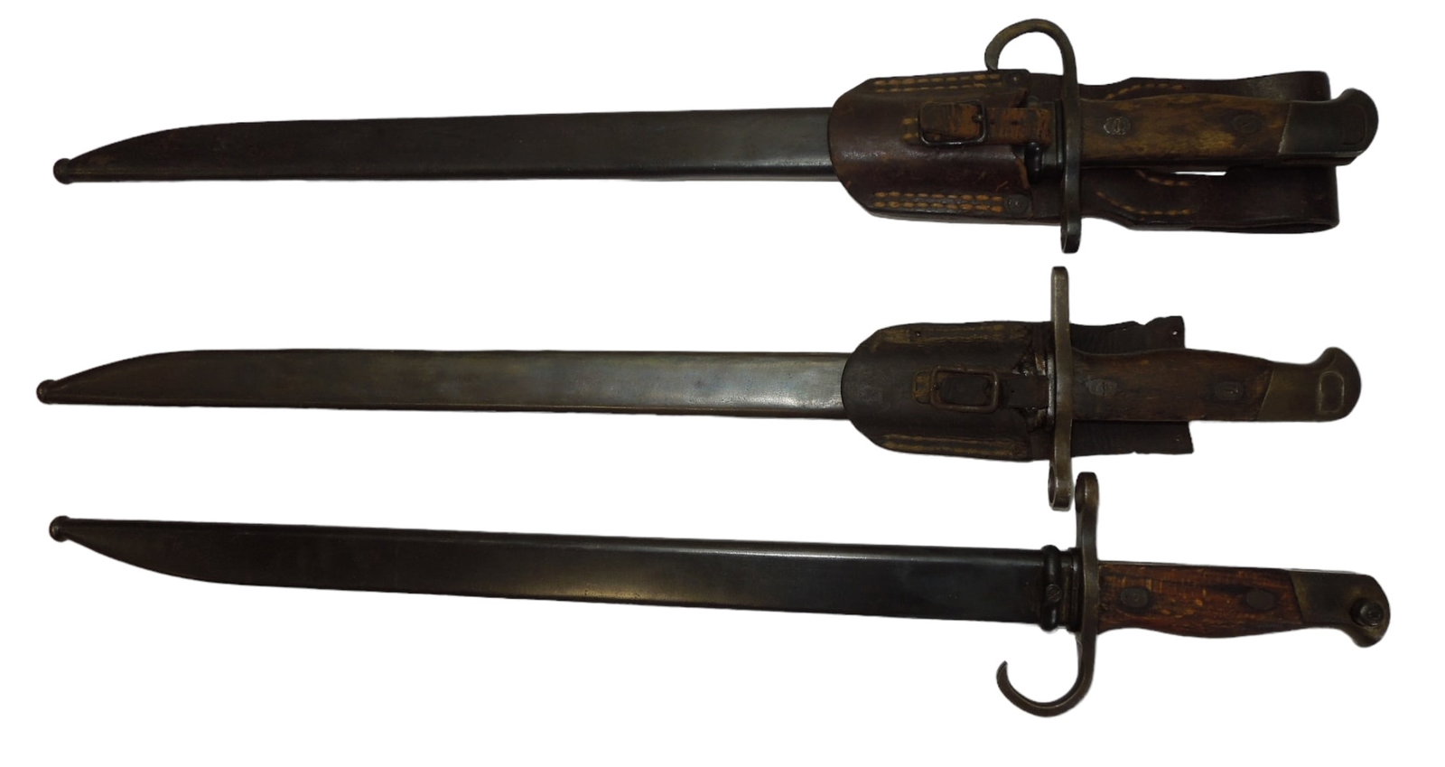 Lot (3) WWII Japanese Army Type 30 Bayonets With Frogs & Scabbards: WWII Japanese Army Type 30 Bayonets With Frogs & Scabbards. Lot of (3). These are the type 30 Hooked Quillon (2) and (1) Straight Quillion bayonets. Based on our research we found the following makers