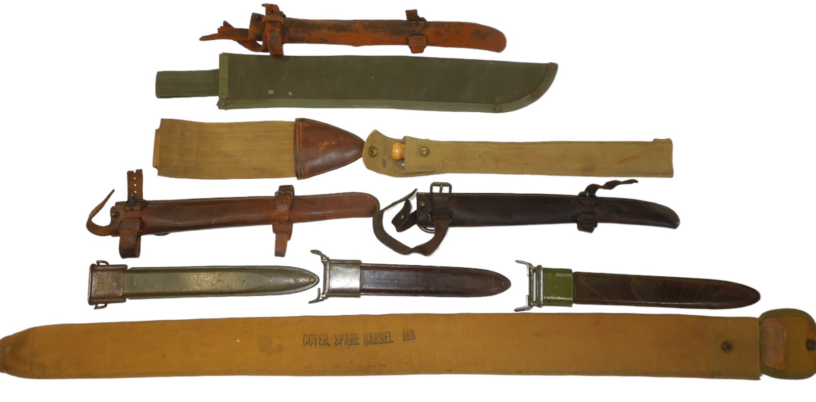 WWI - WWII Lot US Military Scabbards Sheaths Spare Barrel Cover: Lot of items to include M0-1 Garand Bayonet scabbards (one is foreign made), a machete sheath, Bolo knife canvas sheath, M9 spare barrel cover, and three leather scabbard holders. Good condition showi