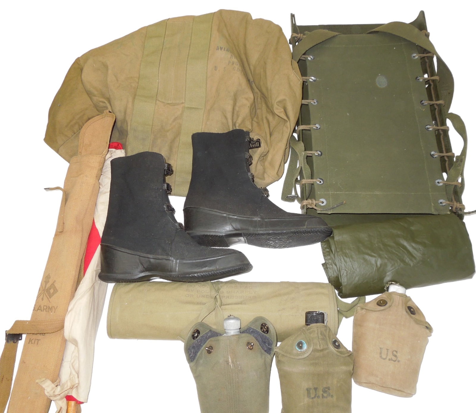 Lot WWI-WWII Military Equipment Poncho Winter Boots Canteens Signal Flag Kit Aviator Bag: Lot WWII US Military Equipment: Poncho, Winter Boots, Canteens, Signal Flag Kit, Aviator Bag. Items as shown. The canteen is marked 1918 L.F. & C. Cup 1945 S.M. Co and still in its original paper. 194