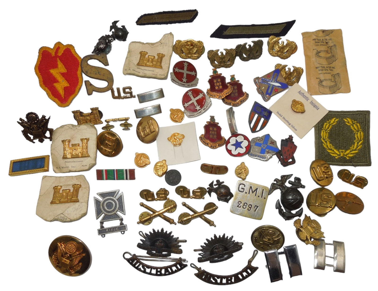 WWII US Military Pins CBI DUI USMC EGAs Badges Patches: Lot of items with highlights being a theater made CBI DUI pin, British made First Lieutenant Bar, Australian Army shoulder marks, GMI worker ID badge, US and Artillery Pins, and more. Fair to Good con