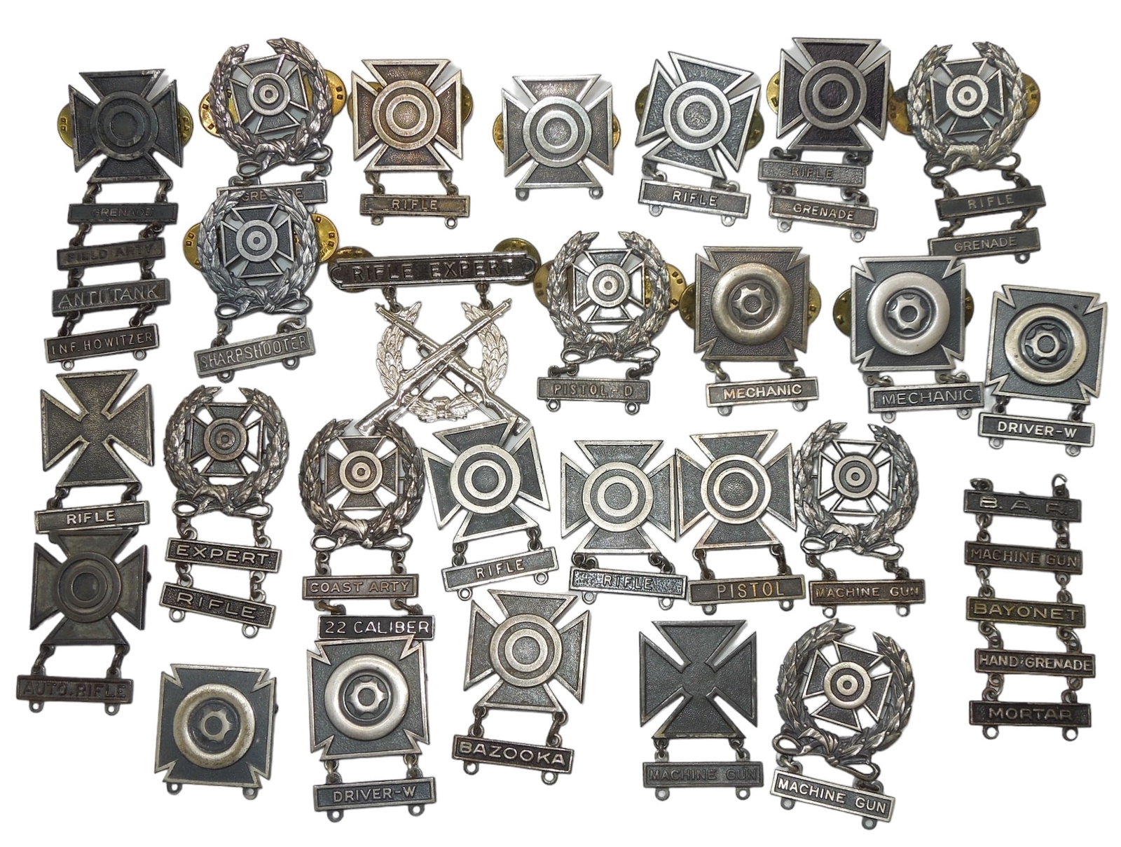 WWII - Vietnam War US Army Marksmanship Badge Pins Some Sterling: WWII - Vietnam War US Army Marksmanship Badge Pins. 25+ pieces. Some pieces are marked Sterling. Some makers include: NS Meyer, Green Inc., L.I.G.I., KREW, Antaya, Jostens, and Fox. Overall, good cond