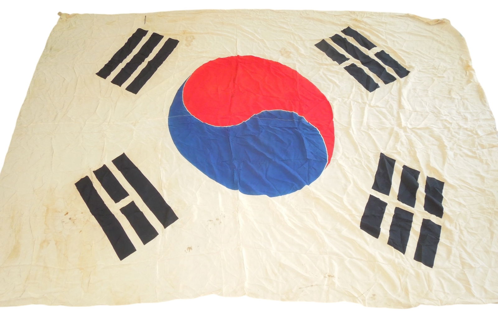 Very Large Korean War Era South Korea National Flag: Large silk flag measuring approximately 66 x 94 inches, with a lot of wrinkles and soiling to the silk material. Both hoist attachments are partially detached. There may be some history with where thi