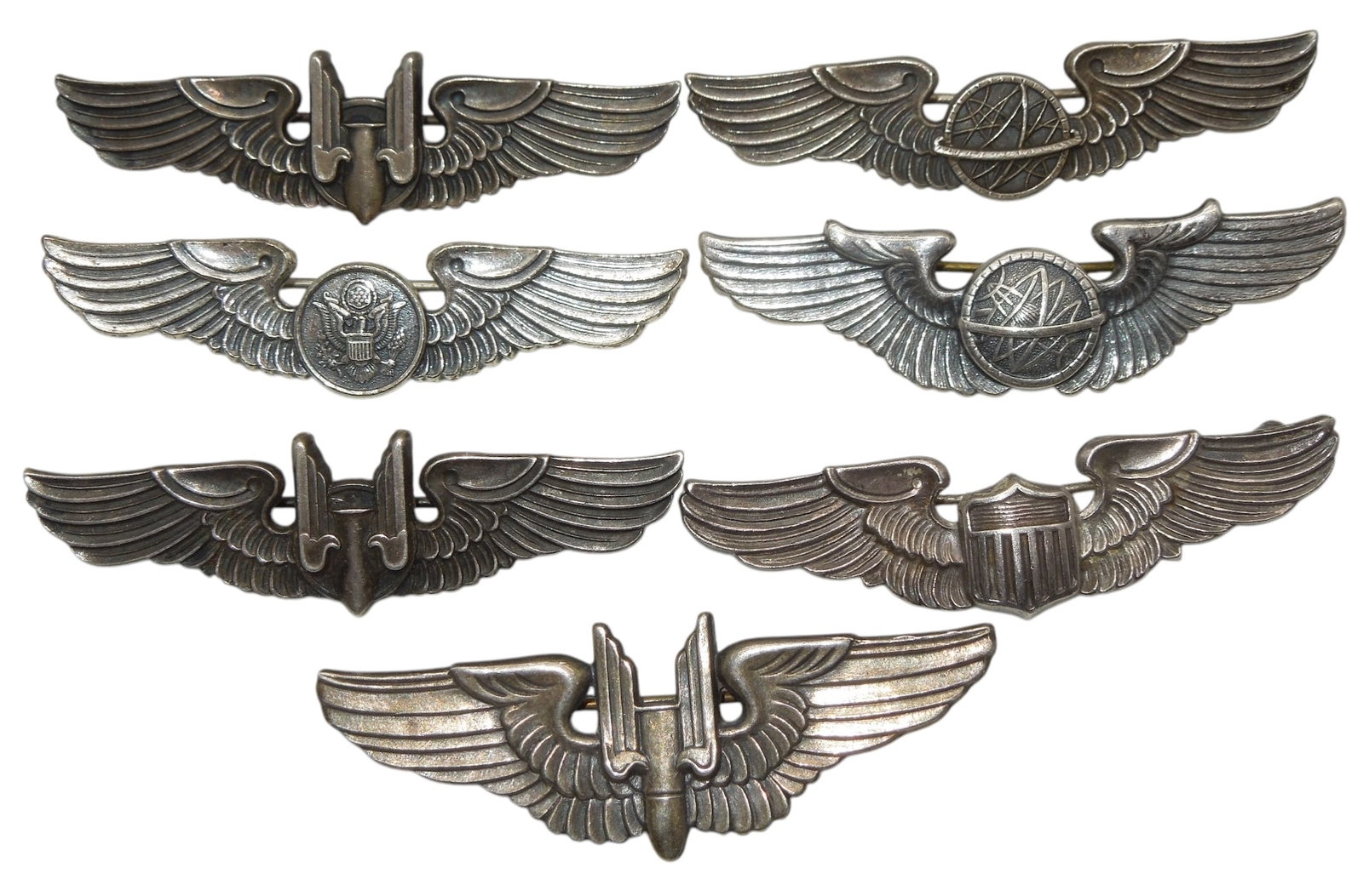 Lot (7) WWII 2 Inch US Army Air Force Gunner & Observer Pilot Sterling Wings: 5 are marked sterling, one is likely sterling and scratched out, the other is Vanguard NY.
