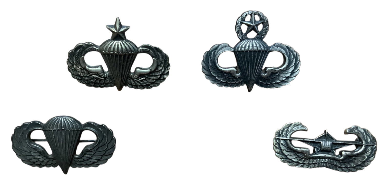 WWII Era Army Master, Senior & Parachutist Badges, Airborne Glider Badge Lot (4): WWII Era US Army Master Parachutist Badge, Senior Parachutist Badge, Parachutist Badges and Airborne Glider Badge. Lot of (4). Three pieces are marked STERLING. Hallmark on one reverse includes: G.I.