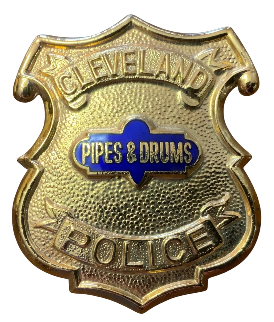1990s Cleveland Police Pipes & Drums Ceremonial Badge: 1990s era Cleveland Police Pipes & Drums Ceremonial Badge. This badge is gold-colored and features a distinctive blue enamel center emblem. No hallmarks on the reverse. Excellent overall condition. Th