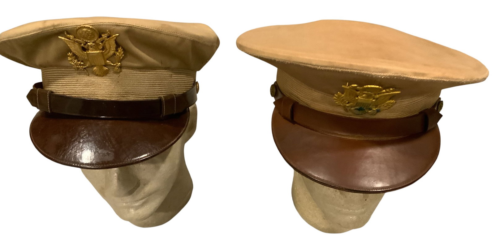 WWII Era US Army Officer’s Khaki Summer Visors Caps Lot (2): WWII Era US Army Officer’s Khaki Summer Visors Caps. Lot of (2). One of the gold-colored US Army officer cap badge has verdigris (see photo). The sizes seen are 7 1/8 and 7. Overall, good condition 