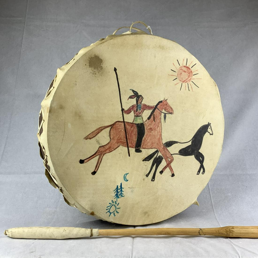 20th C. Native American Indian Painted Drum: Here is a mid-20th century original Native American Indian pained drum and beater. Hide covered on both sides with painted turtle, horse and rider, etc. Drum is 17 inches wide by 4 1/2 inches tall. Ex