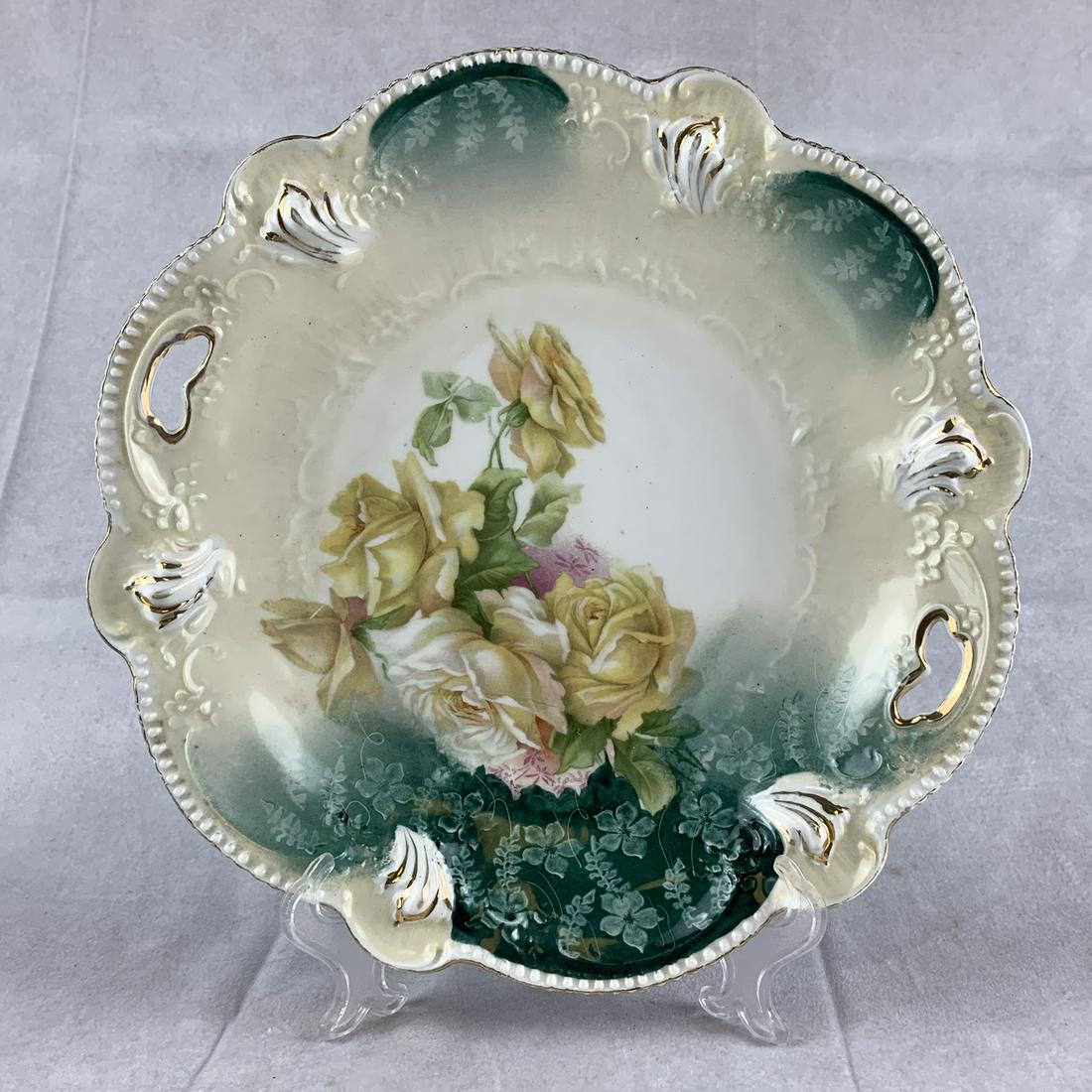 R. S. Prussia Red Mark Molded Open Handle Cake Plate: 11” open handled R. S. Prussia red mark cake plate. Moulded out floral. NO DAMAGE, clean.