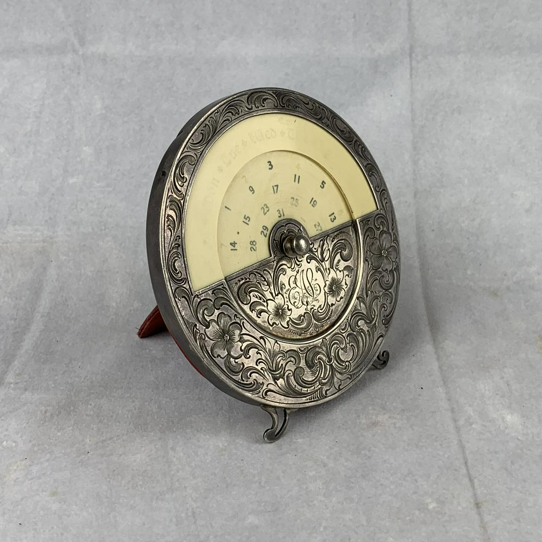Fancy Sterling Desk Top Clock: An early sterling silver desk top calendar with engravings.