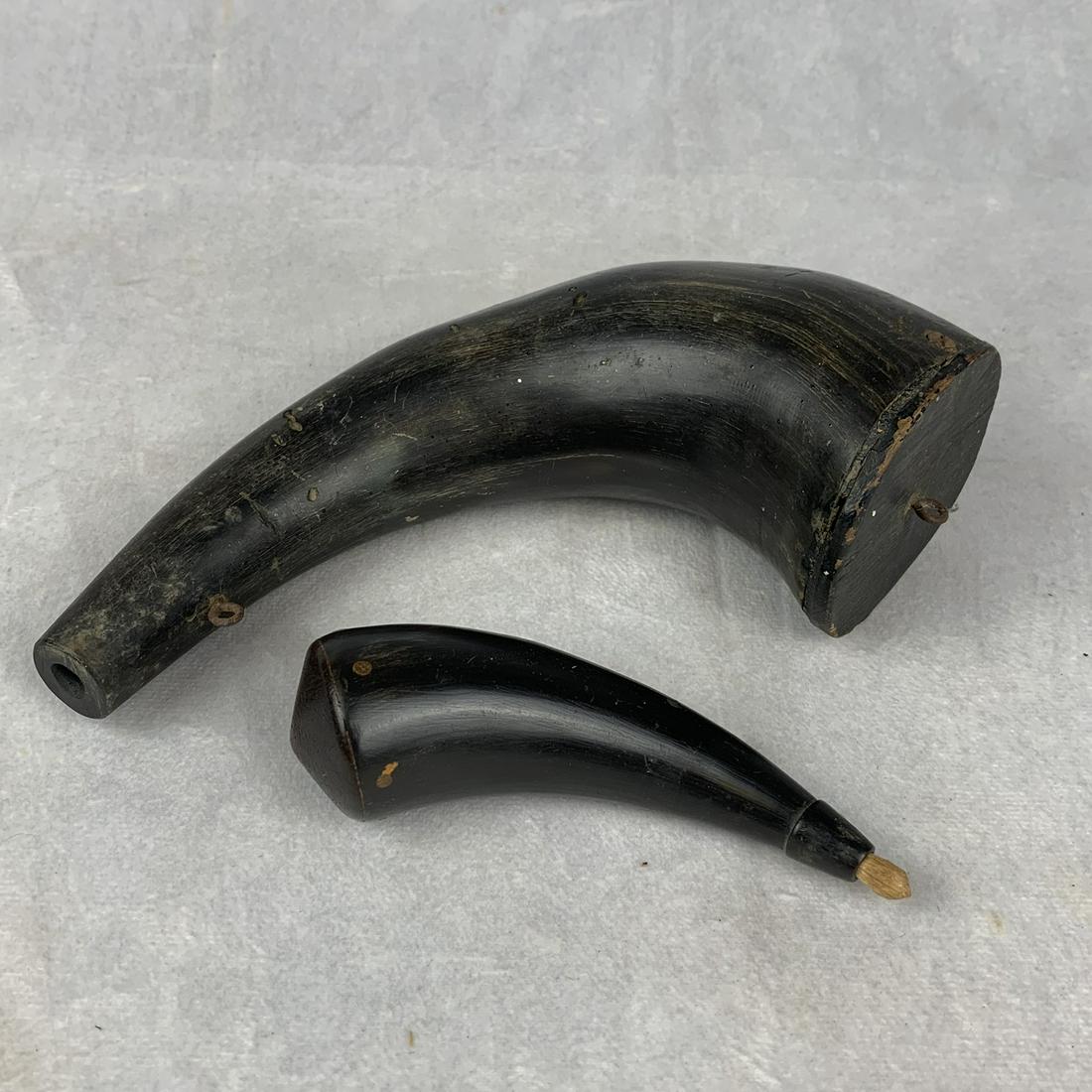 Pair of Antique Horn Powder Horns: Two antique horn powder horns. One 9 inches and one 5 inches. Both have original wood caps. Small one excellent larger one has a few bug eaten spots on one side.