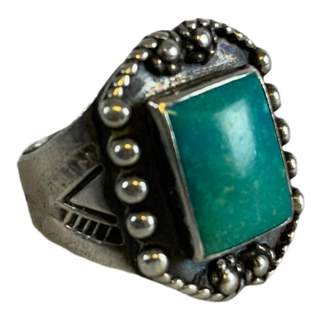 Unique Old Pawn Vintage Fred Harvey Era Navajo: Navajo old pawn coin silver hand stamped ring. The size 9 1/4 ring has chevrons and uniquely long arrow stamps on the shank. Set with a rectangular 1/2" by 3/8" turquoise stone on an oval plate border