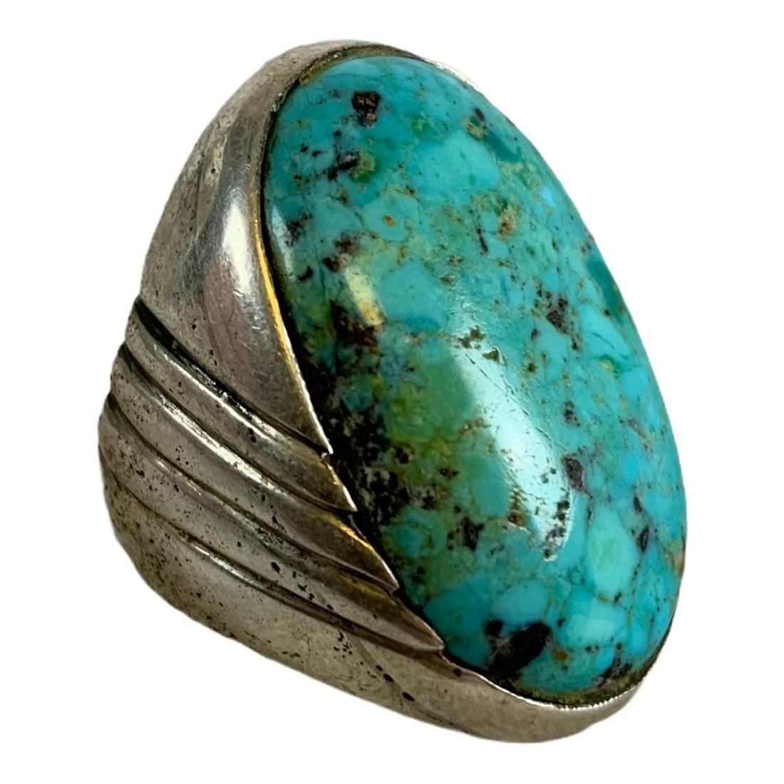 Heavy Large Navajo Turquoise Sand Cast Coin Silver: Navajo old pawn sandcast coin silver hand chisel stamped large ring. The size 8 ring has diagonal deeply chiseled lines on the sides. Set with a beautiful large high domed 1 1/4" by 3/4" oval blue tur