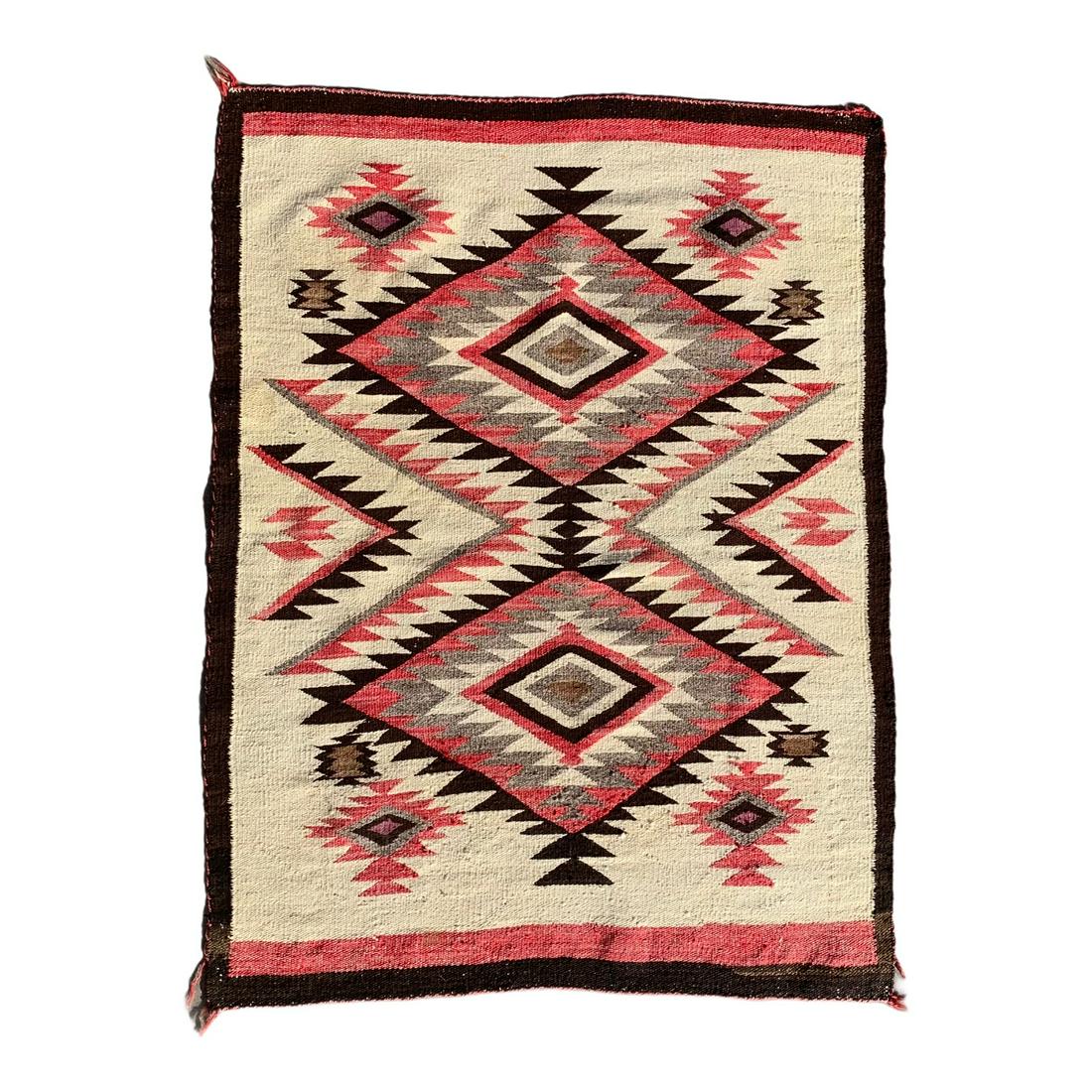Navajo Regional Rug: Circa 1920 -1930Homespun yarn in white, browns, carded gray and aniline red. Bold Serrated Eyedazzler Diamond PatternTightly woven with lots of lazy lines and light wear & soiling with one stain spot 