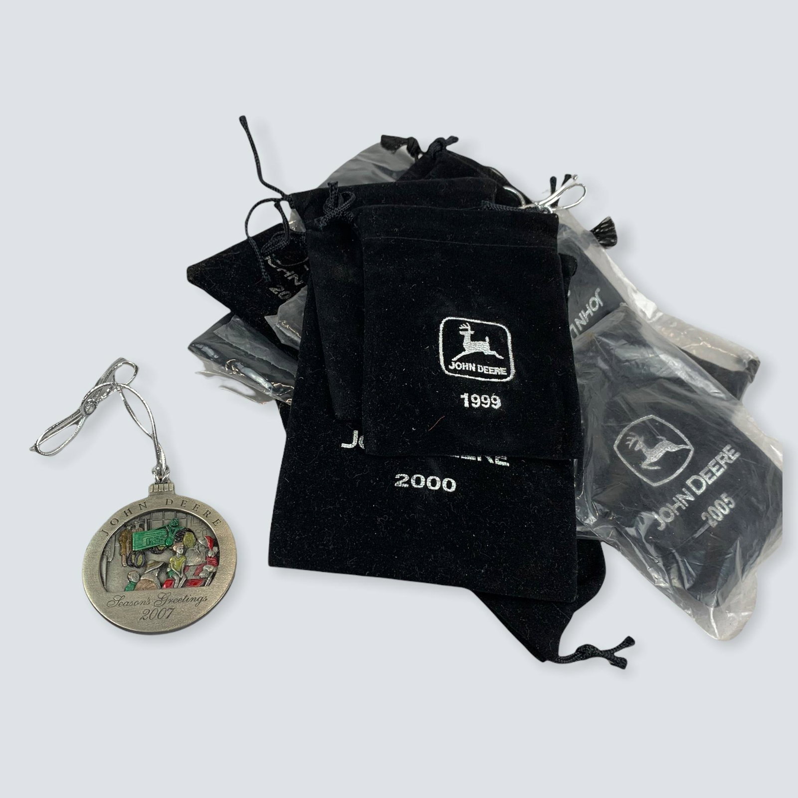 John Deere Christmas Ornaments: 13 John Deere Christmas Ornament Medals 1999-2007. In there original Cloth cases.