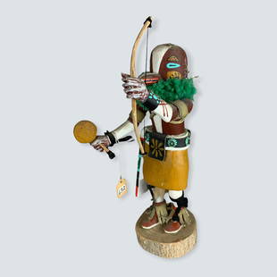 Kachina with Rattle & Bow: Good kachina with rattle in one hand and bow in the other, 12. Says â€œ Badger â€œ95 â€œ on bottom. Excellent