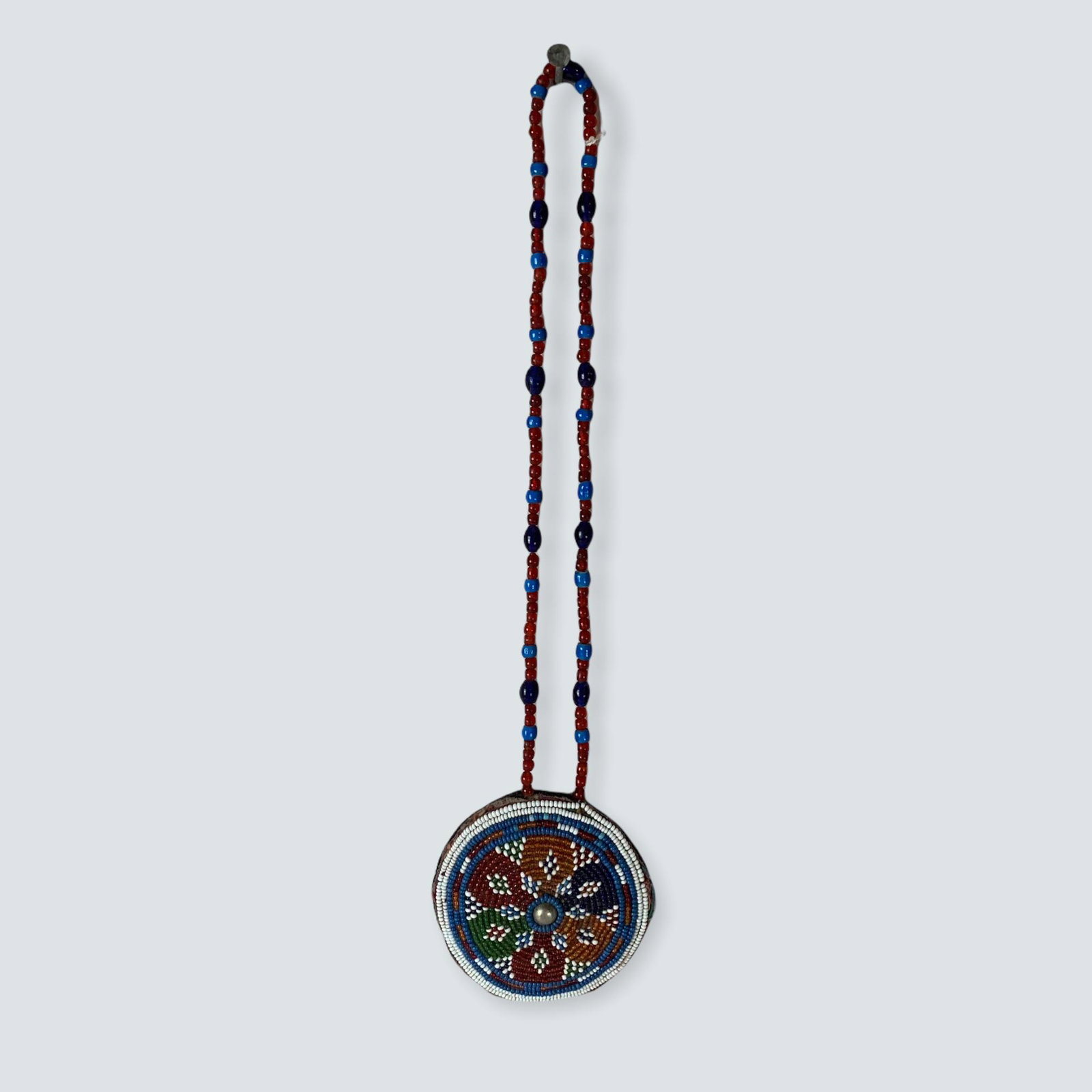Full Beaded Rosette Necklace: A 4 round full beaded rosette with silver dot in the center. Built into it is a glass beaded necklace. Glass beaded necklace is 12 long. Excellent, circa 1900