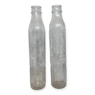 Pair of 1920s Shell Oil One Quart Embossed Glass Bottles: Two (2) matching Shell glass bottles. Measures 15.5 tall.