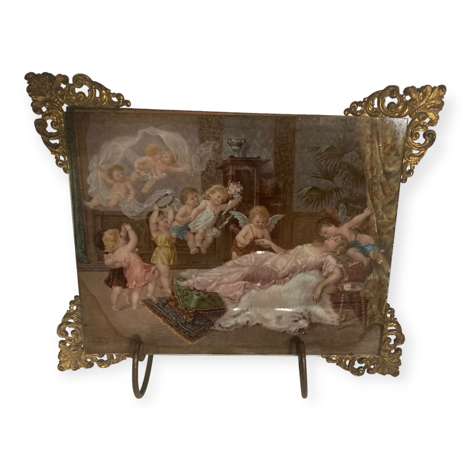 Victorian Glass Picture With Cherubs In Stand: Early glass picture with reclining lady and cherubs. Gold corners, Original stand.11 x 9. Excellent