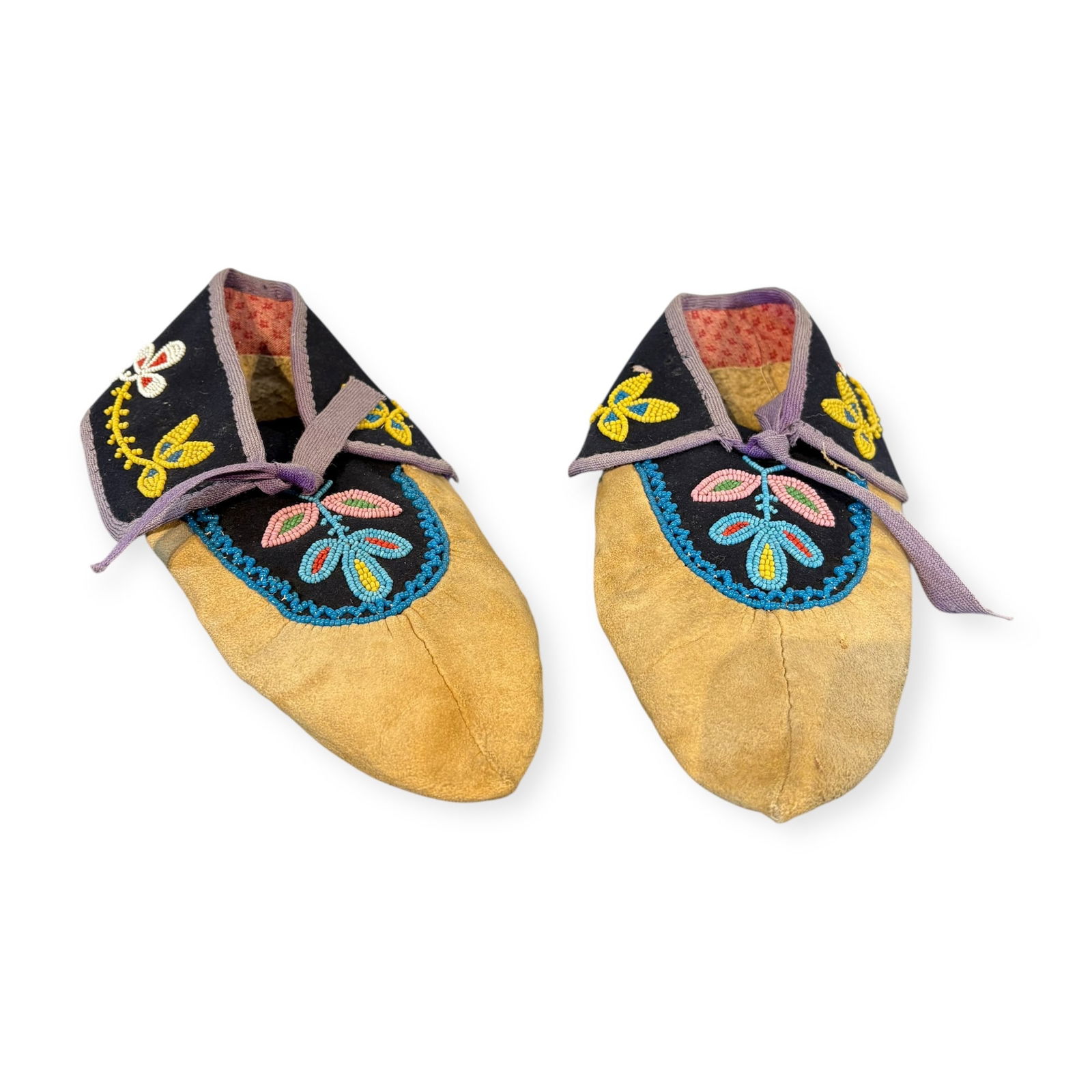 Ojibwa Beaded Pucker Toe Moccasins: Measuring approx 9.5 inches in length, beaded on blue trade cloth. Surviving in very good condition. Circa 1910-1920.