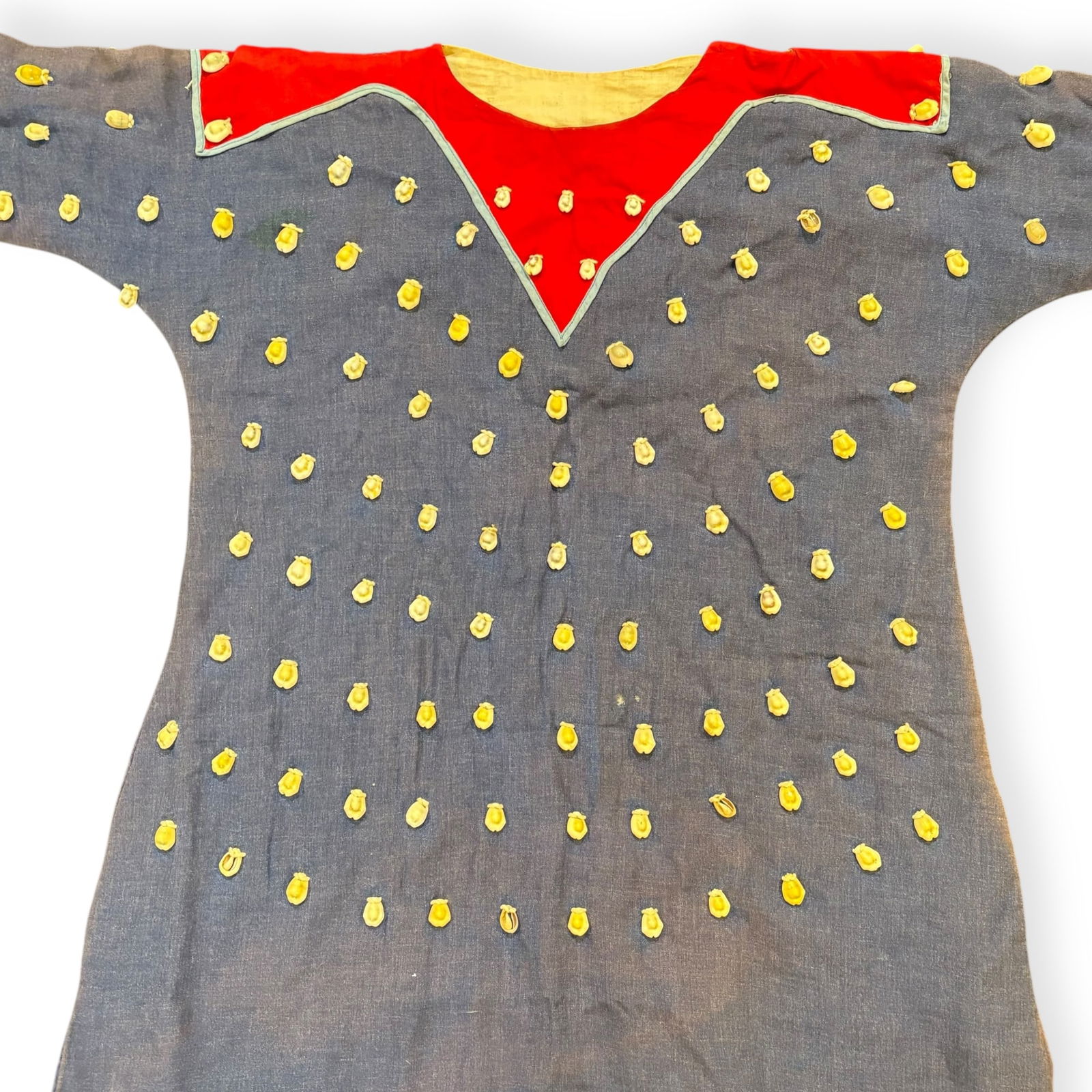 Crow Childs Dress With Over 200 Cowrie Shells: Good vintage Crow child's adorned dress with over 200 cowrie shells. Shells fastened to old blue and red lined cloth . 31 inches long x 44 inches from sleeve to sleeve. Excellent original condition. D