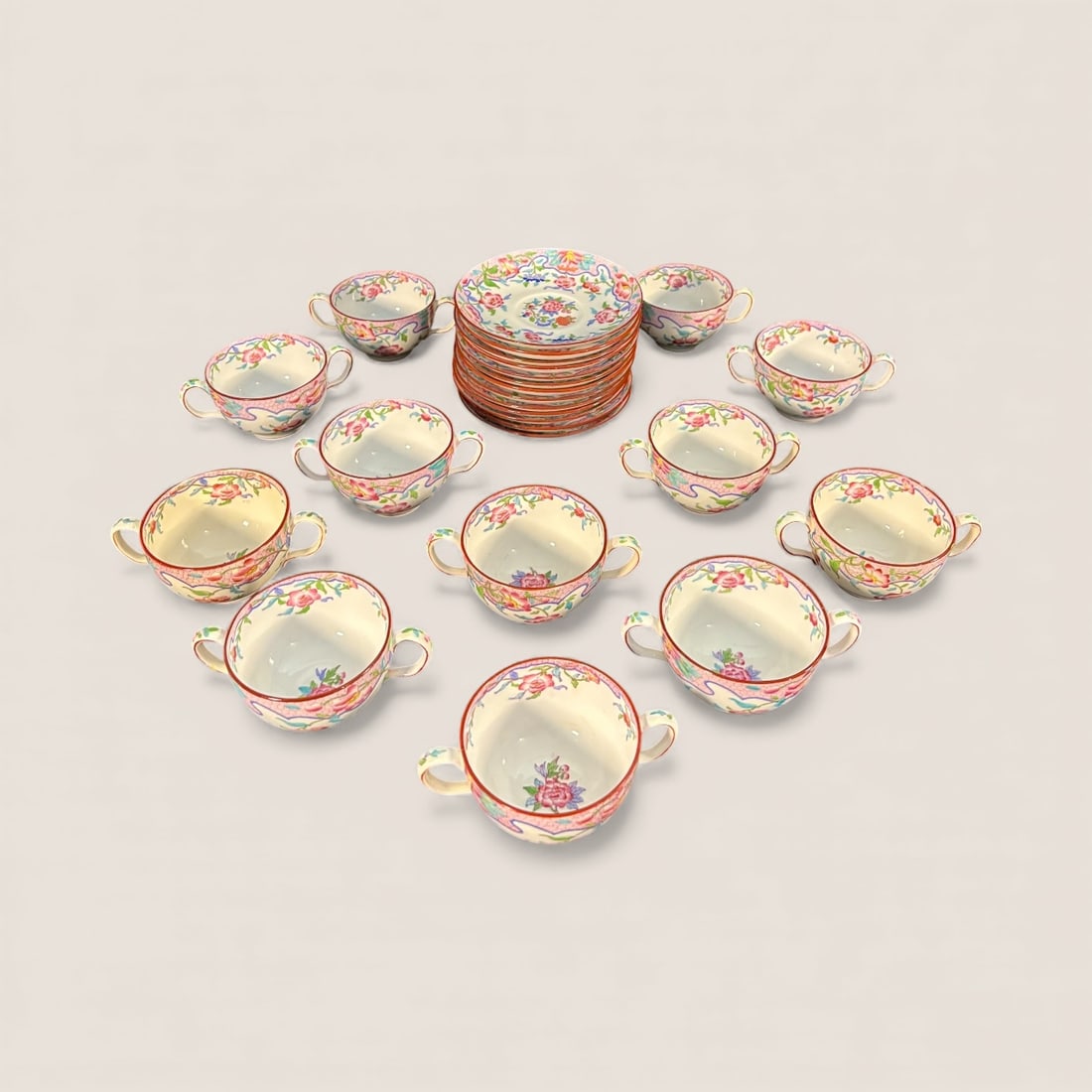 Minton Fine China Double Handled Cups And Saucers: Set of 12 doubled handled cups and 13 saucers. Made by Minton.