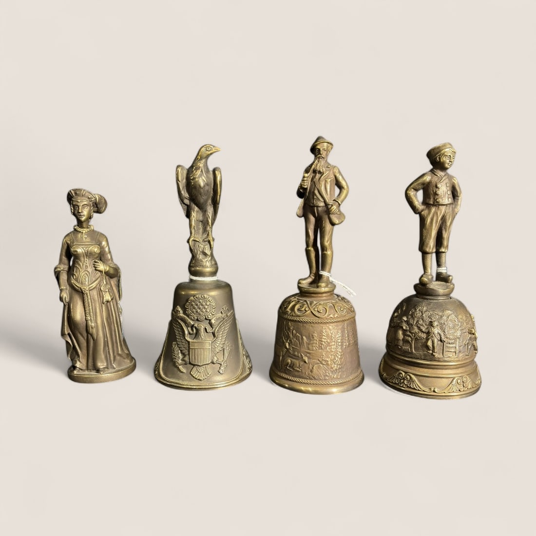 4 Figural Ballantyne Bells: Hans Brinker - Thoreau - Am. Eagle - & Catherine bronze bells. 4 3/4 to 6 inch. All good
