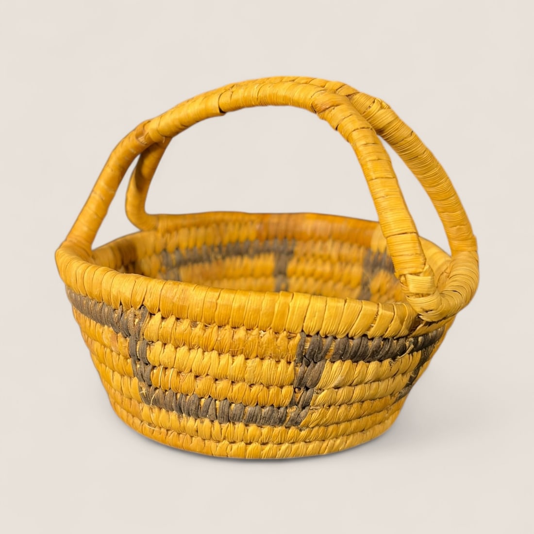 Handled Popago (Tohono O'odham) Basket: Measuring 4 inches tall, including handle.
