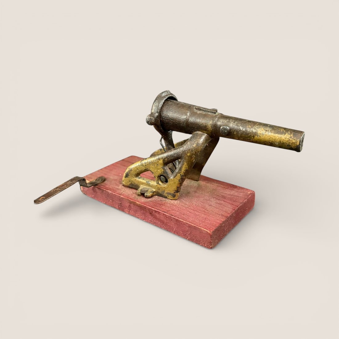 Folk Art Antique Toy Cannon: Unique Homemade Toy Cannon. 5 1/2 inches long. Iron with wood base. You pull spring loaded pan down and release to fire., Very cool To bid with us directly, please visit Ziebarths.com (18% buyers prem