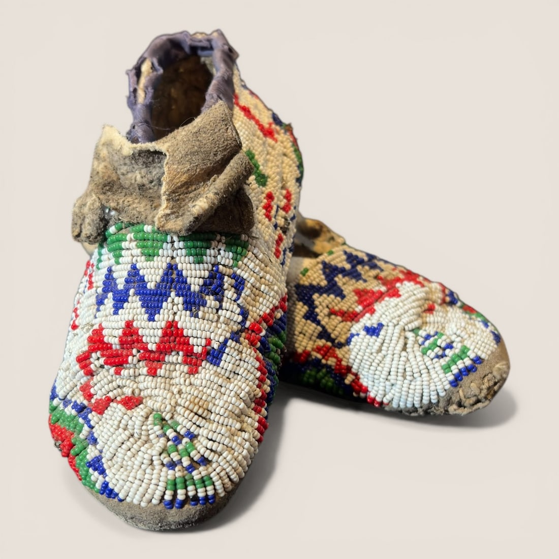 Plains Native American Child's Moccasins: Measuring 6 inches in length, early childs mocs. Circa 1890. Some damage and bead loss as pictured. To bid with us directly, please visit Ziebarths.com (18% buyers premium). We offer affordable,