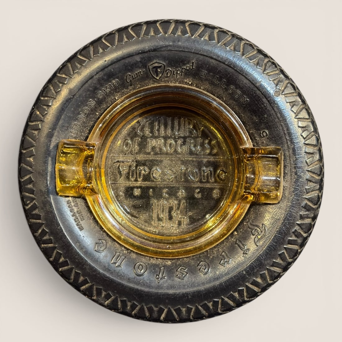1934 Firestone Century of Progress Chicago World's Fair Souvenir Ashtray: This is a promotional souvenir ashtray produced for the Firestone Tire and Rubber Company exhibit at the 1934 Chicago World's Fair, known as A Century of Progress. The item features a miniature