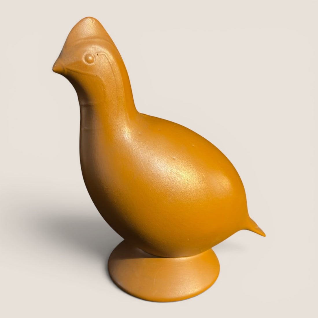 Red Wing Pottery Ed Knop Stylized Quail Figurine in Mustard Yellow Glaze: This is a stylized ceramic bird figurine, identified as a quail or partridge, designed by Ed Knop for Red Wing Pottery. The piece features a mid-century modern aesthetic with a rounded, simplified bod