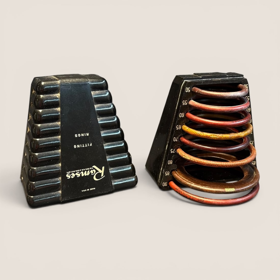 A Vintage Ramses Diaphragm Fitting Ring Set by Julius Schmid Inc.: This lot features a mid-20th-century medical diagnostic set designed for sizing diaphragms, manufactured under the Ramses brand by Julius Schmid, Inc. The set consists of two molded black Bakelite