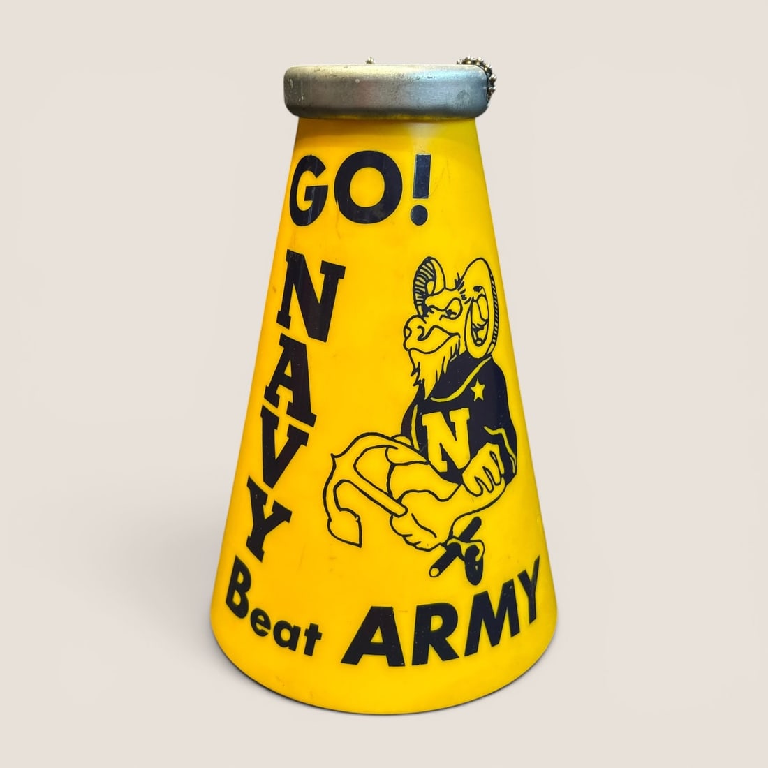 Vintage US Naval Academy Souvenir Megaphone Go Navy Beat Army: A vintage collegiate souvenir megaphone representing the United States Naval Academy (Navy Midshipmen). The object consists of a conical yellow plastic body featuring navy blue printed graphics. The
