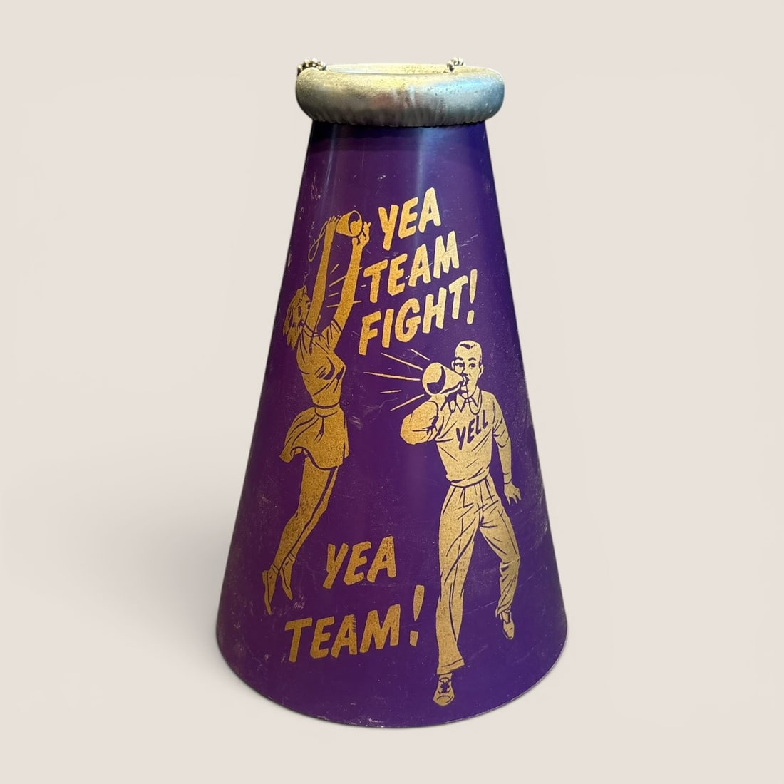 Vintage Purple and Gold Cheerleading Megaphone Attributed to Yell-a-Phone: A mid-20th-century cheerleading megaphone, identifiable as a Yell-a-Phone model, featuring a classic conical design. The body is constructed of a rigid material, likely heavy-duty pressed fiberboard