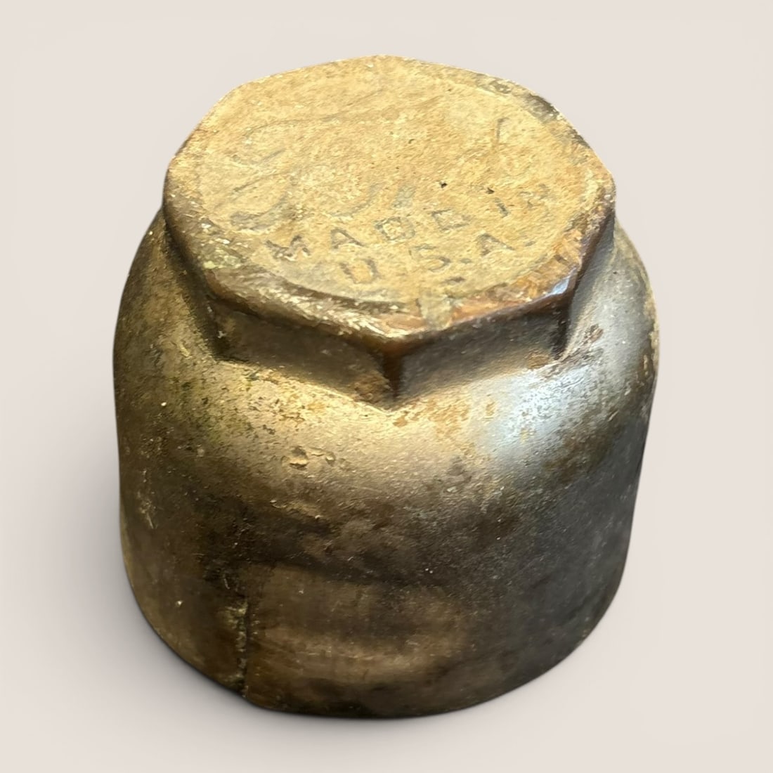 Vintage Ford Model T Grease Cup Cap: This vintage grease cup cap is an early 20th-century automotive component featuring an embossed script logo for the Ford Motor Company. Constructed from cast brass, the cap is designed with a hexagona