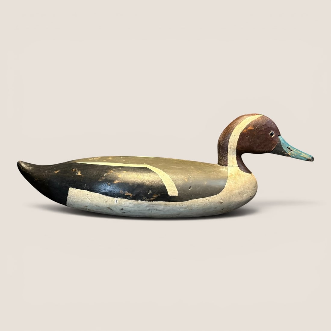 Folky Early Wooden Duck Decoy: Vibrant colors, found in the midwest, blue bill. Measures approx 18 inches in length. Good condition.We provide in-house shipping on all items in the auction. Bid directly at Bid.Ziebarths.com for a