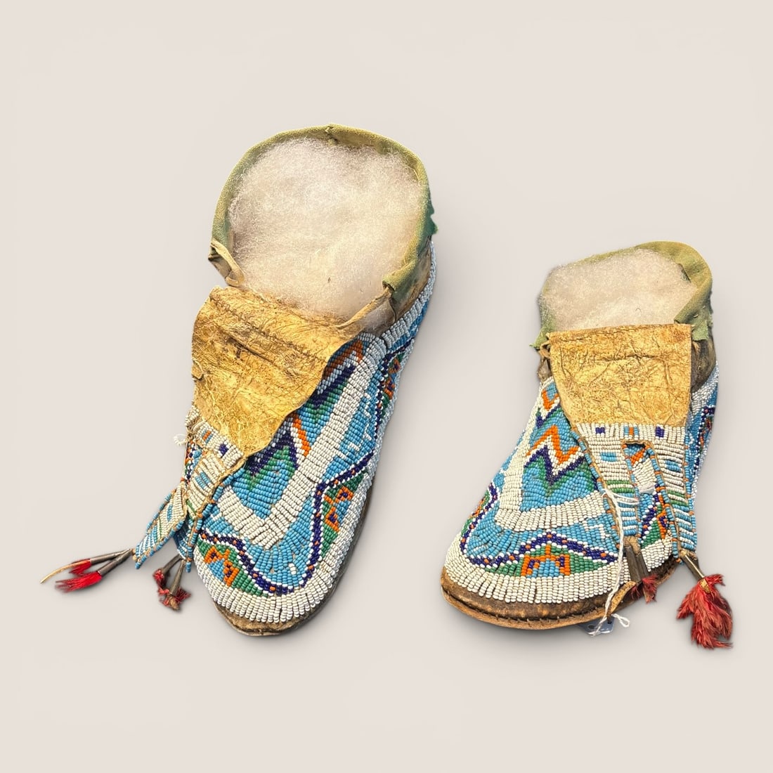 Sioux Moccasins With Tongues: Excellent condition, measuring 10 inches in length. Some bead damage, but a fine pair.We provide in-house shipping on all items in the auction. Bid directly at Bid.Ziebarths.com for a lower buyers