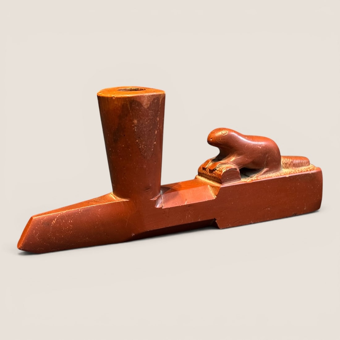 Figural Native American Catlinite Pipe Bowl: Measures 6 3/4 inches in length x 3 inches tall, a figural otter on the pipes stem. Good condition.We provide in-house shipping on all items in the auction. Bid directly at Bid.Ziebarths.com for a