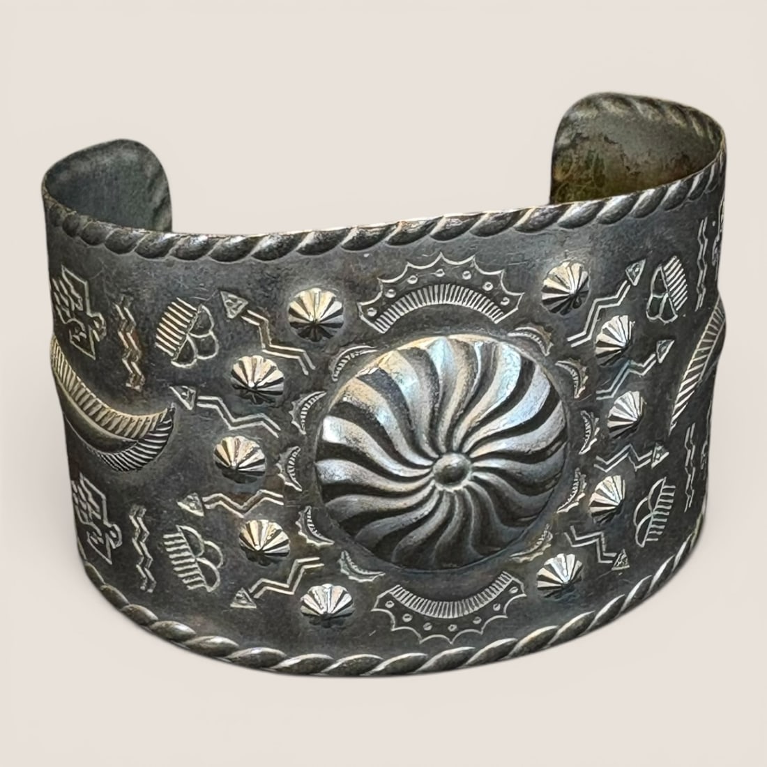 Fred Harvey Era Bracelet: Excellent stamped bracelet with figures, measures approx 1 3/4 inches in width. Measures 2.5 inches across.We provide in-house shipping on all items in the auction. Bid directly at Bid.Ziebarths.com f