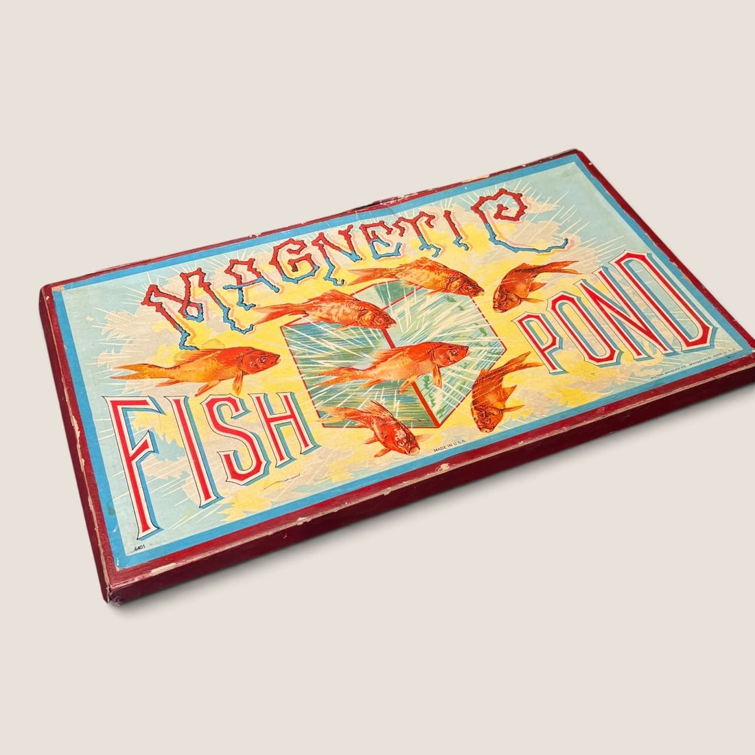 Antique No. 4401 Milton Bradley Magnetic Fish Pond Game: Graphic antique Milton Bradley Magnetic Fish Pond game complete with board fish and pole. Box cover has side damage Bid directly at Bid.Ziebarths.com for a lower buyers premium (18%). We offer in-hous